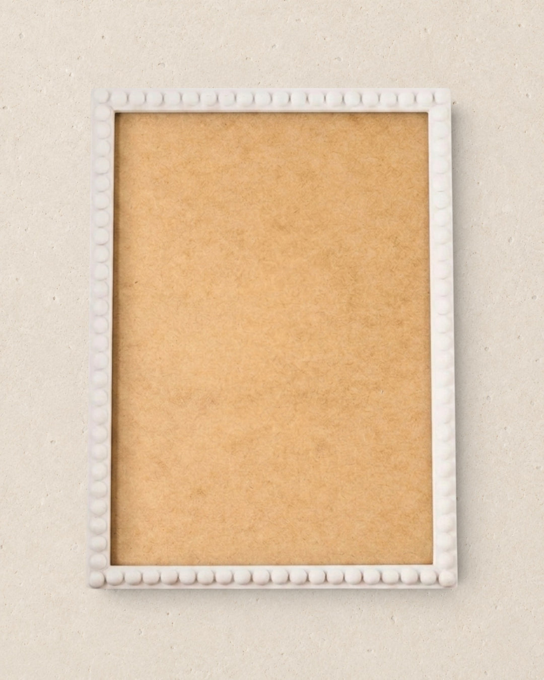 White picture frame on a beige wall