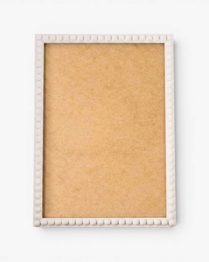 White picture frame with a bobbin border on a white background
