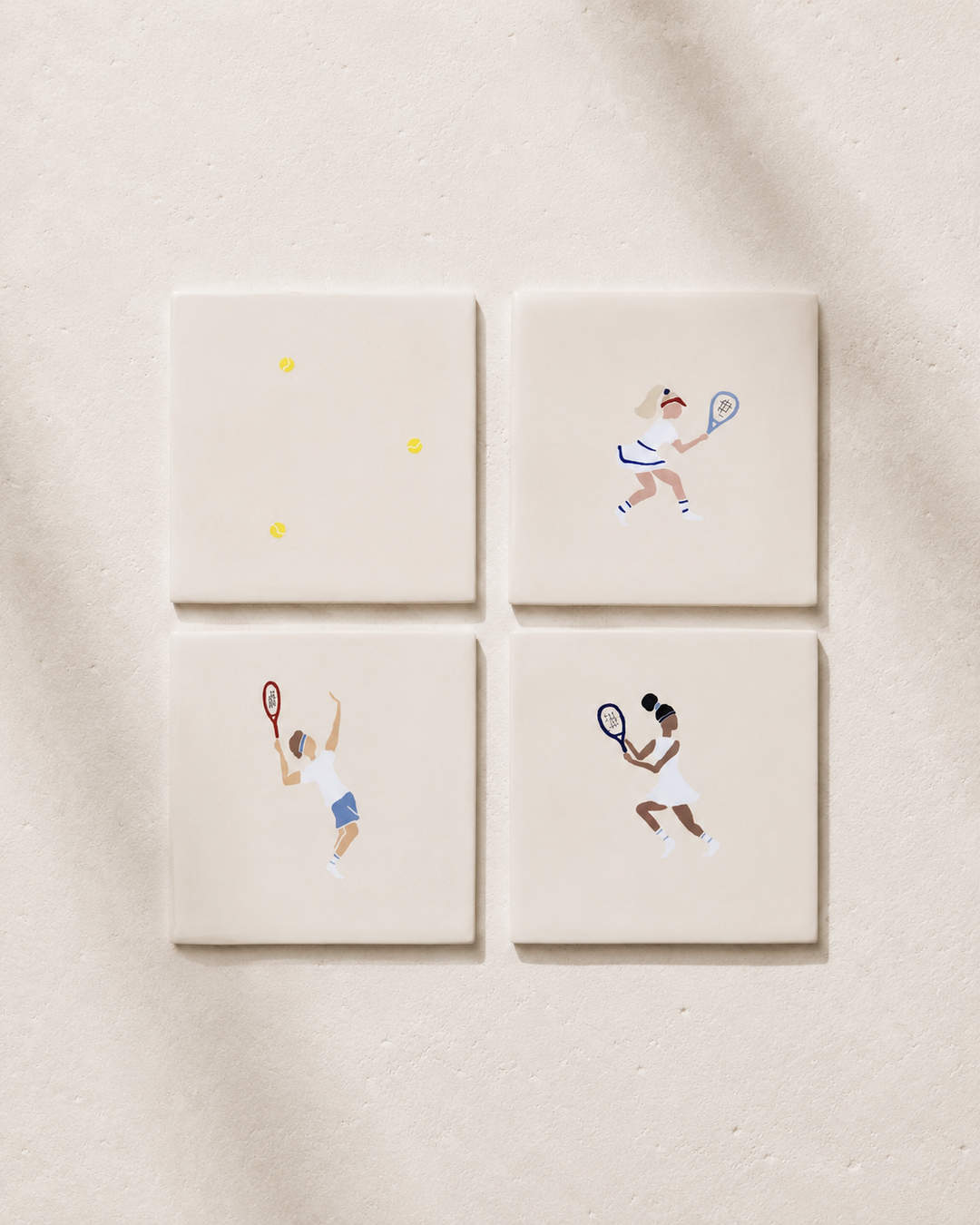 Four square coaster tiles with illustrations of a tennis player on a beige background