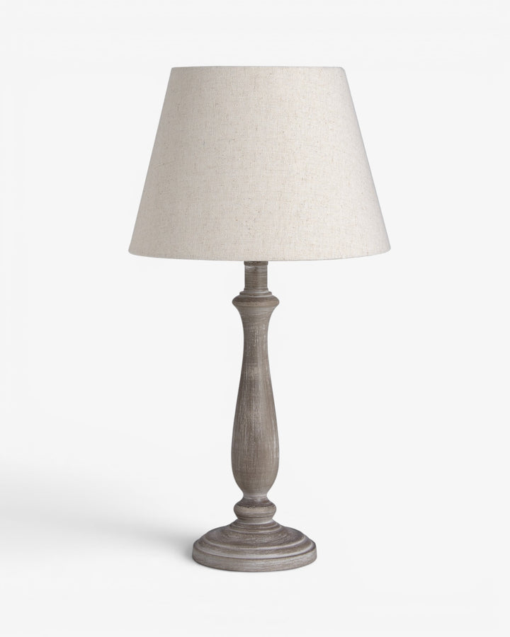 Table lamp with a beige shade on a white background