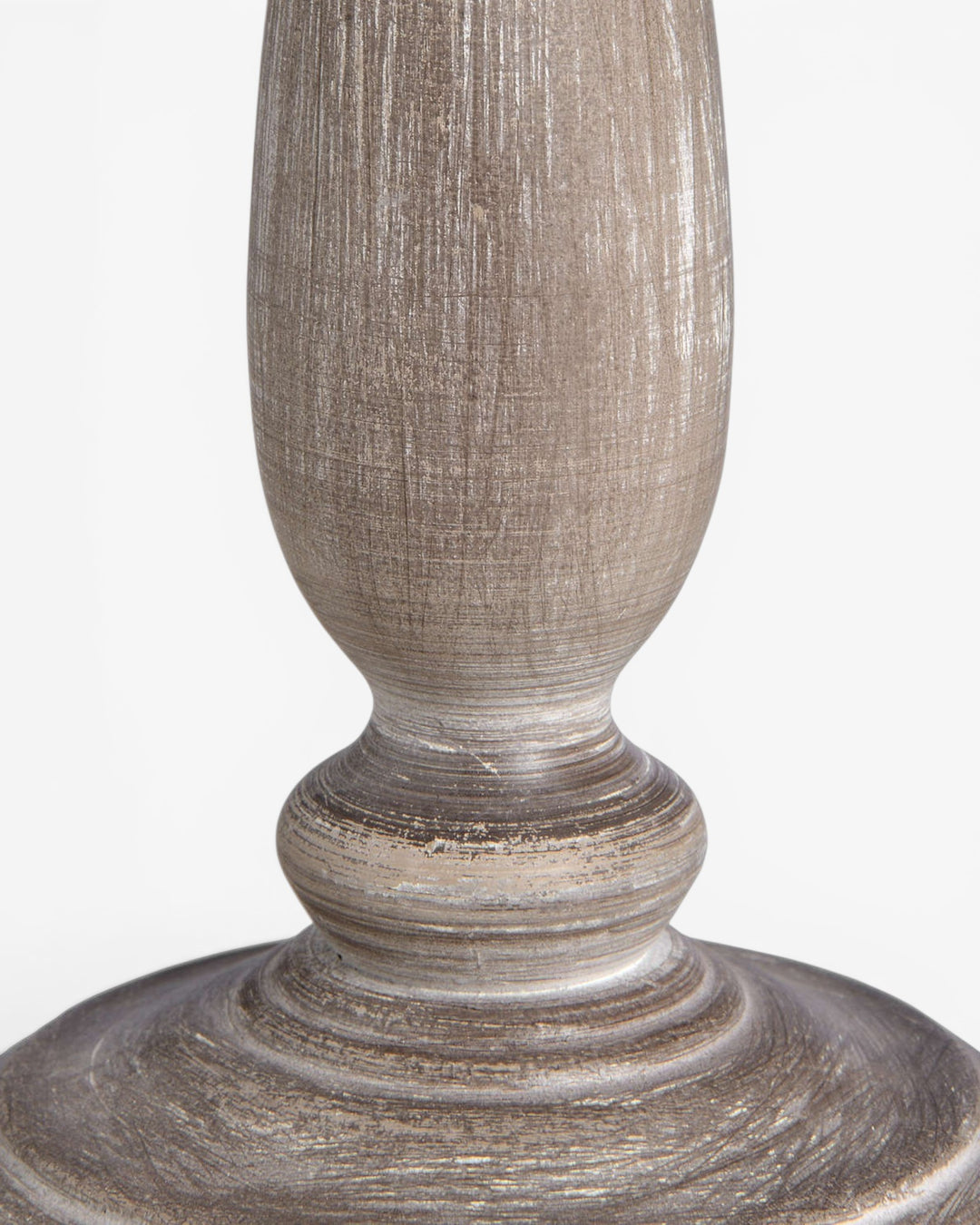 Decorative wooden lamp base with textured surface on a white background