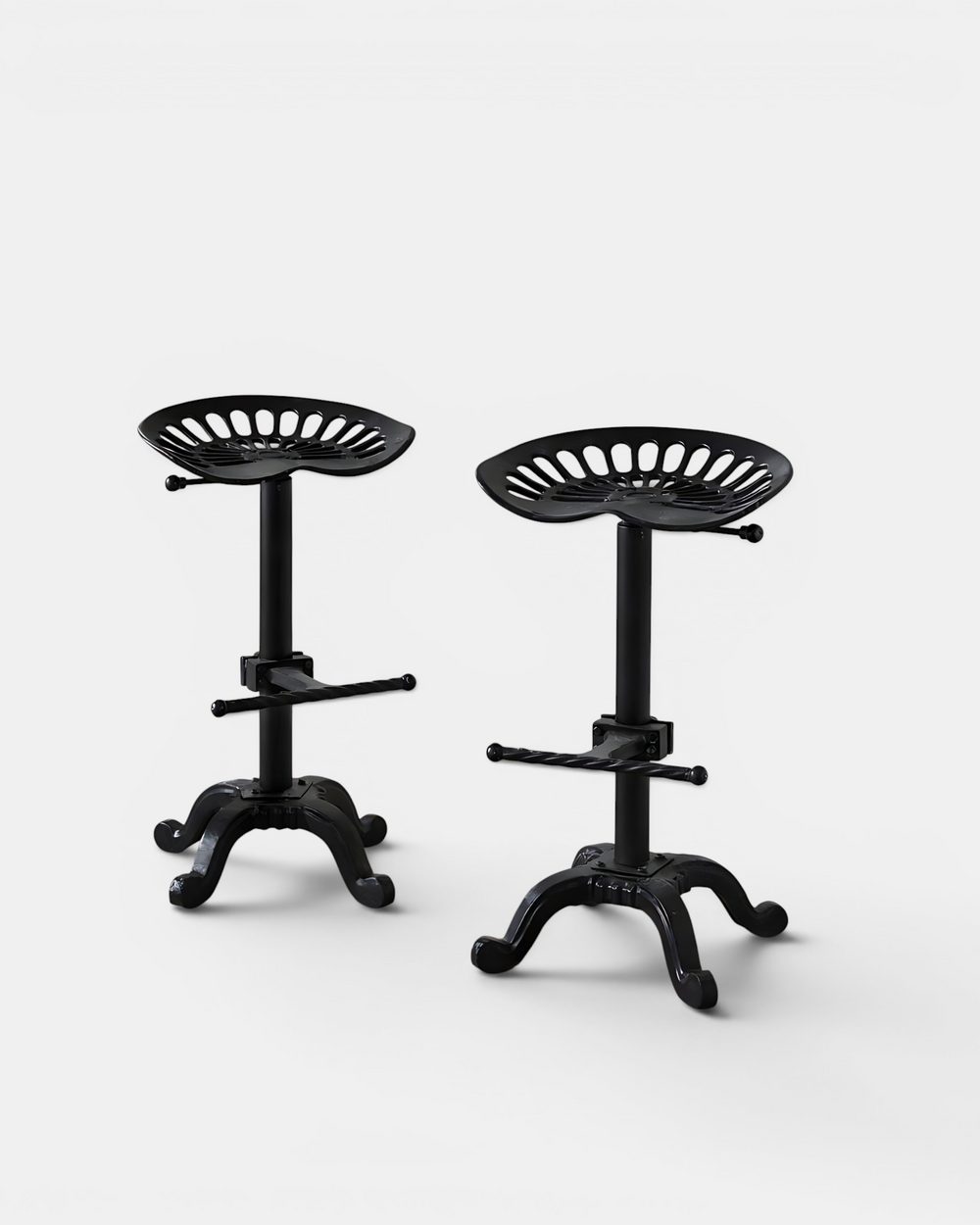 Two black bar stools with adjustable seats on a white background