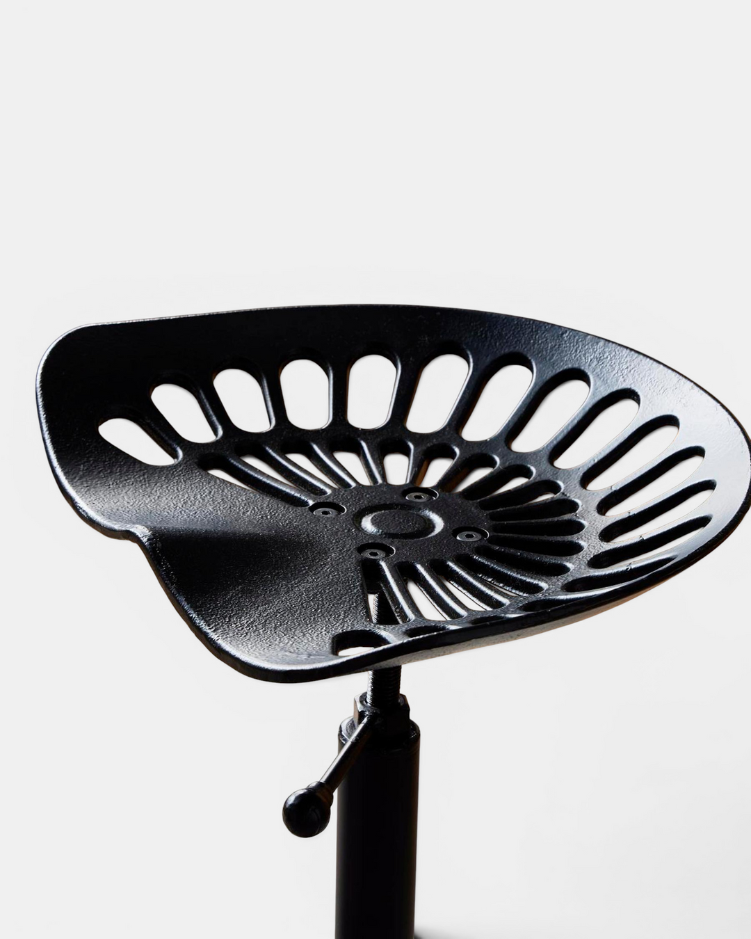 Black metal bar stool with a unique design on a white background