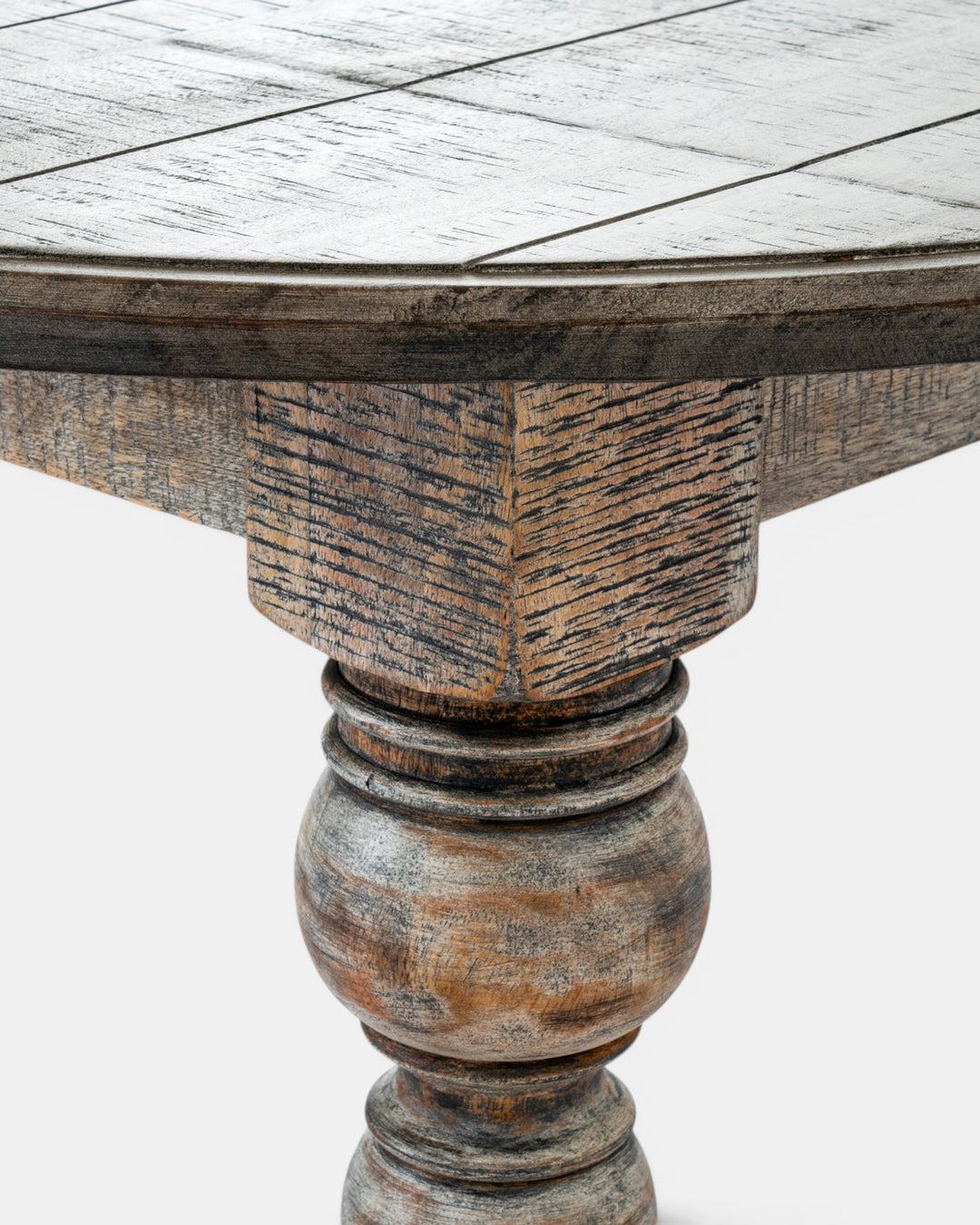 Round wooden table with a detailed pedestal base on a white background