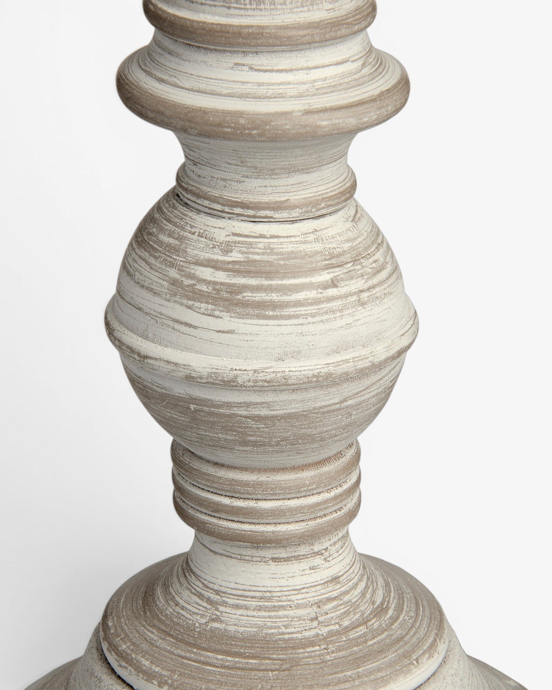 Close-up of a textured wooden lamp base on a white background