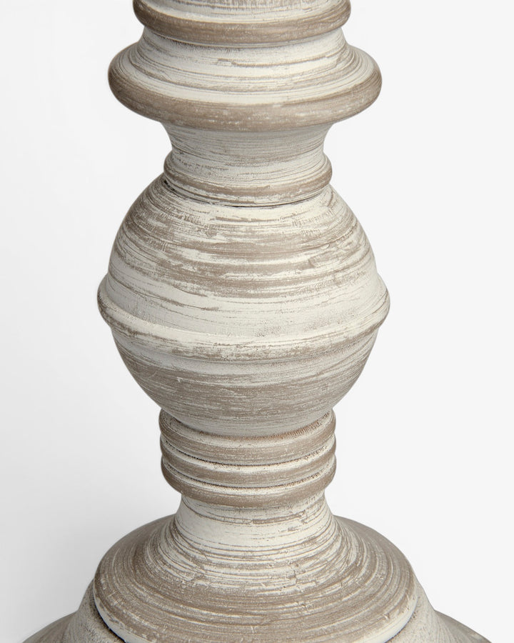 Close-up of a textured wooden lamp base on a white background