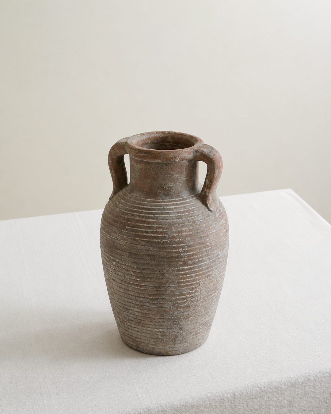 Ceramic vase on white table with white background