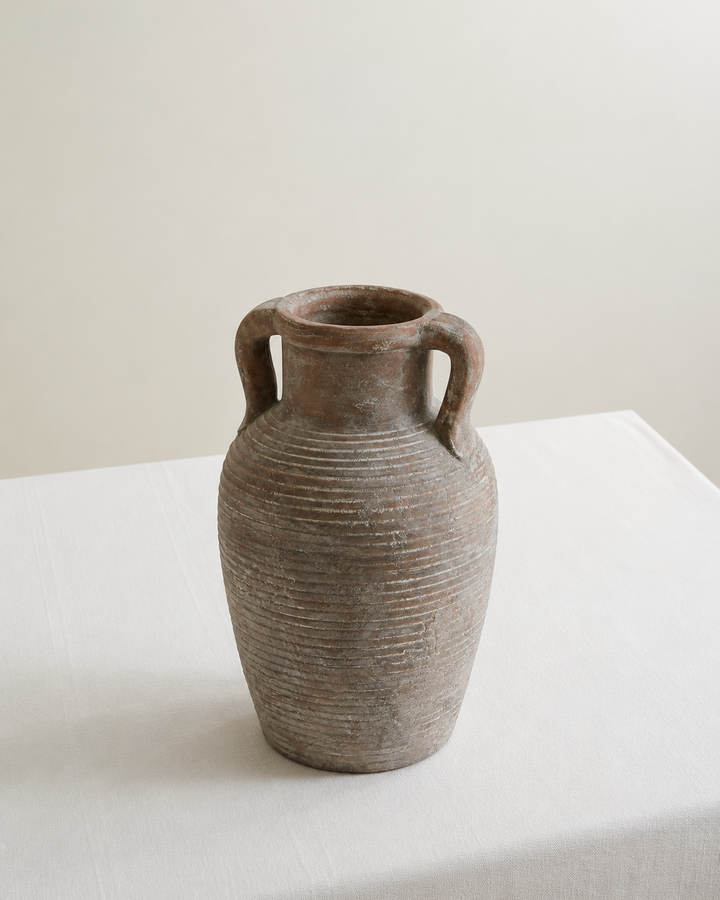 Ceramic vase on white table with white background
