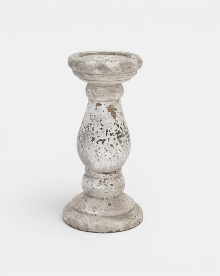 Decorative candle holder with a rustic finish on a white background