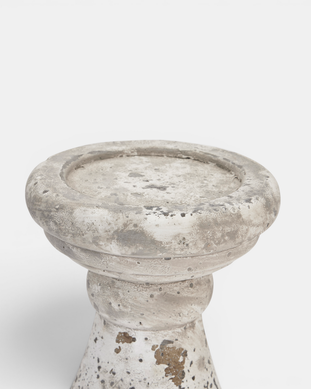 Beige candle holder with textured surface on a white background