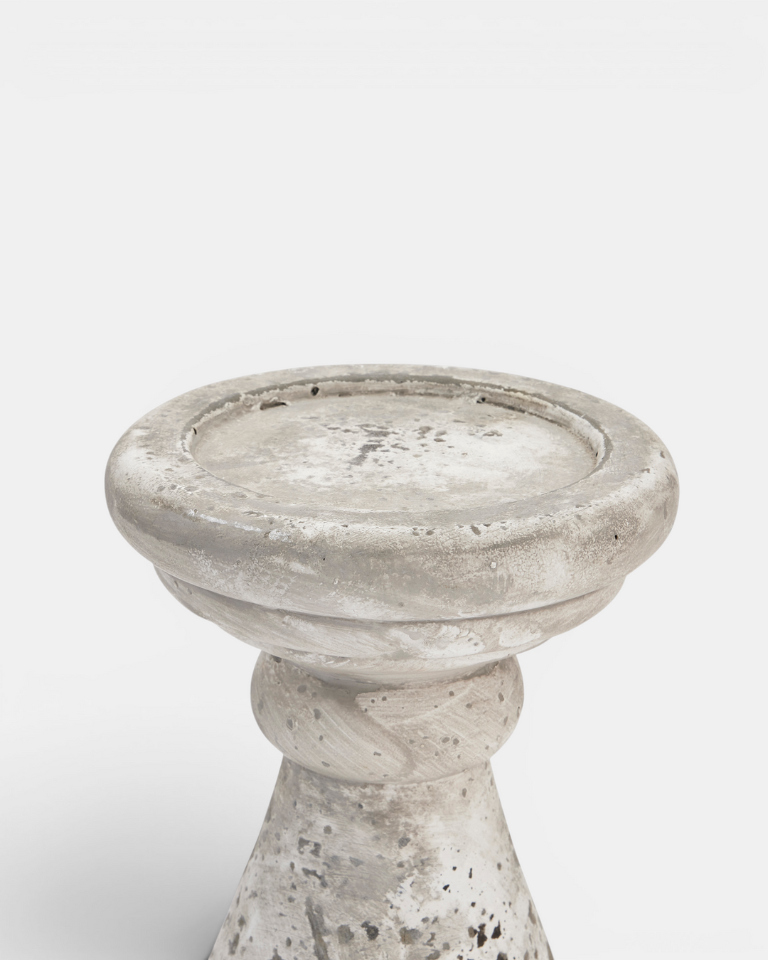 Beige candle holder with textured surface on a white background