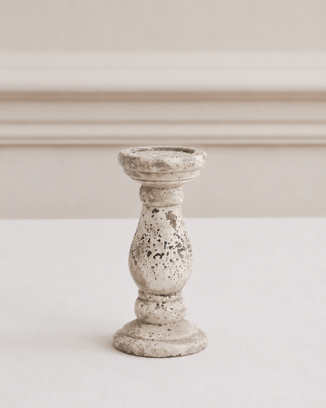 Decorative candle holder with a textured surface on a plain background