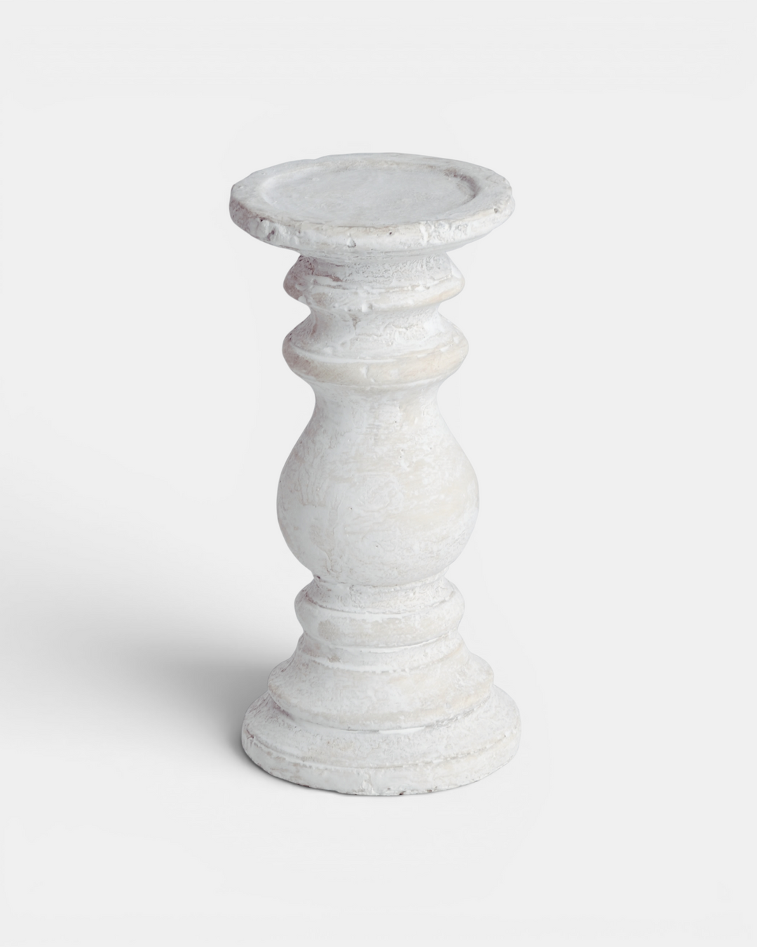White ceramic candle holder on a light gray background