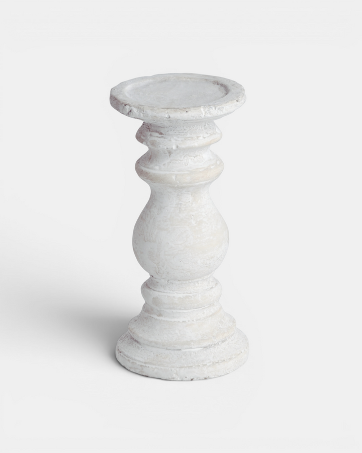 White ceramic candle holder on a light gray background