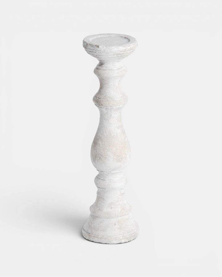 White candle holder on a light gray background