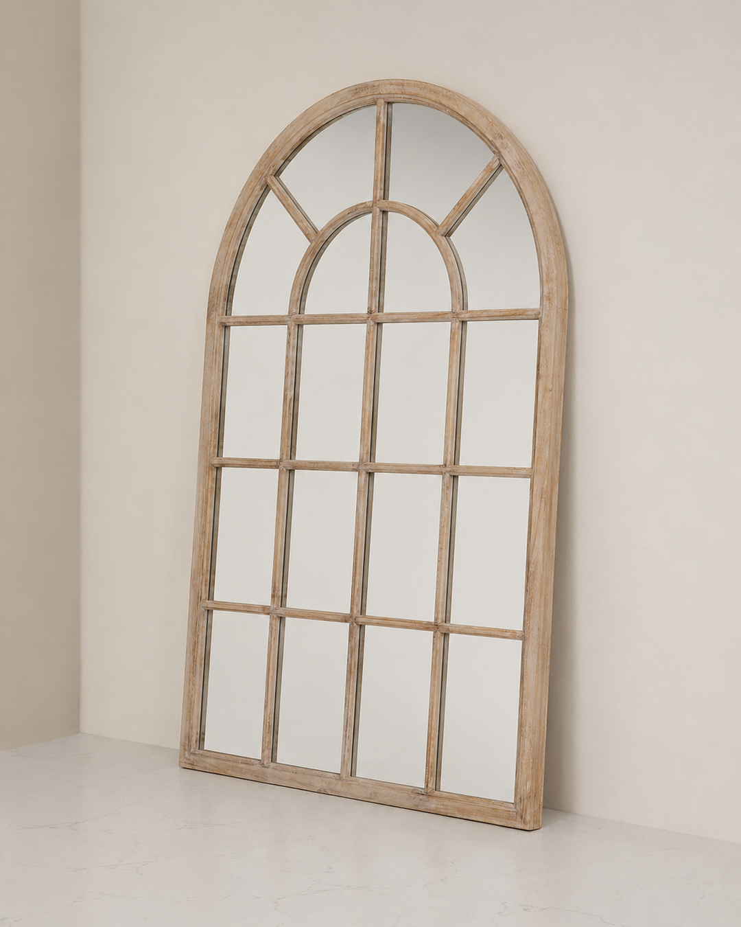 Wooden arch-shaped mirror on a plain wall