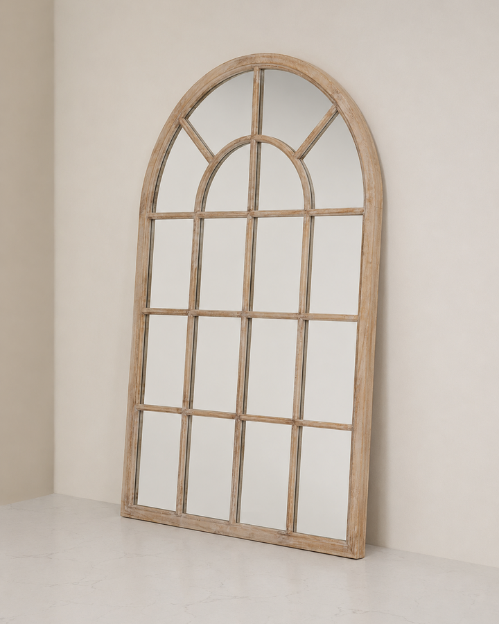 Wooden arch-shaped mirror on a plain wall