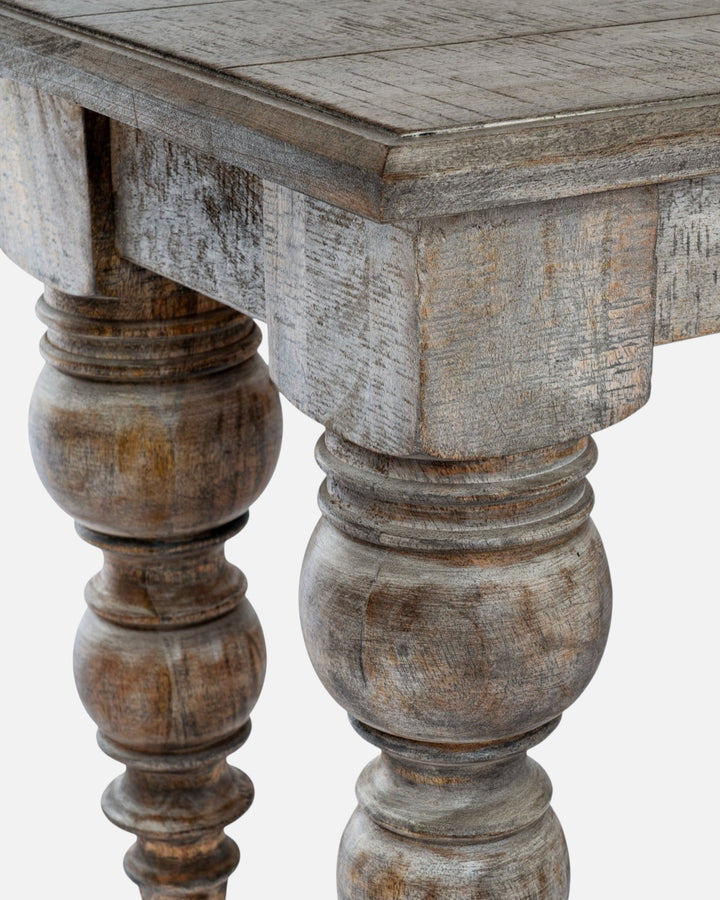 Byretto Laurel bench featuring a rustic grey-brown weathered wood finish and detailed turned legs.