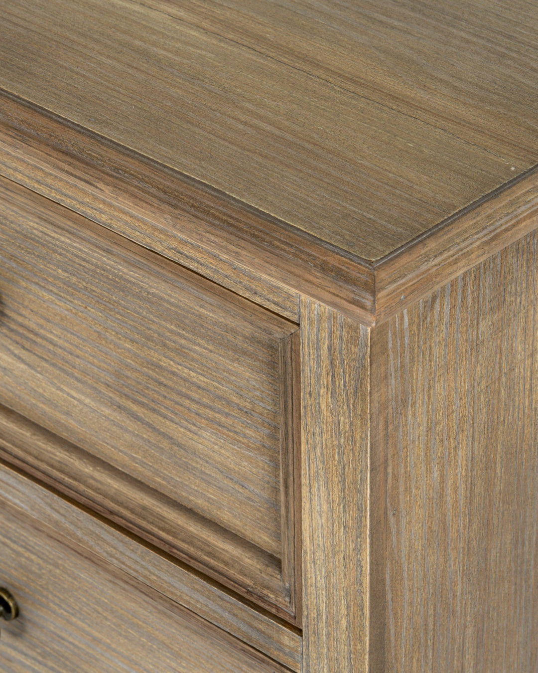 Close-up of a wooden cabinet corner with a focus on the grain and texture.