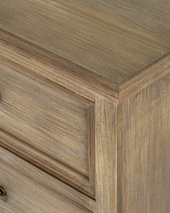 Close-up of a wooden cabinet corner with a focus on the grain and texture.