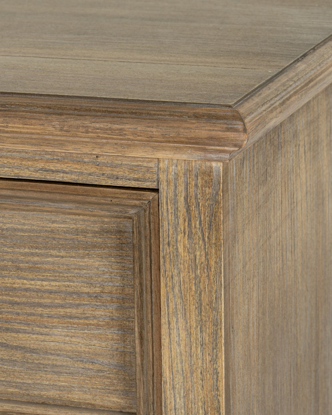 Close-up of a wooden cabinet corner with a focus on the grain and texture.
