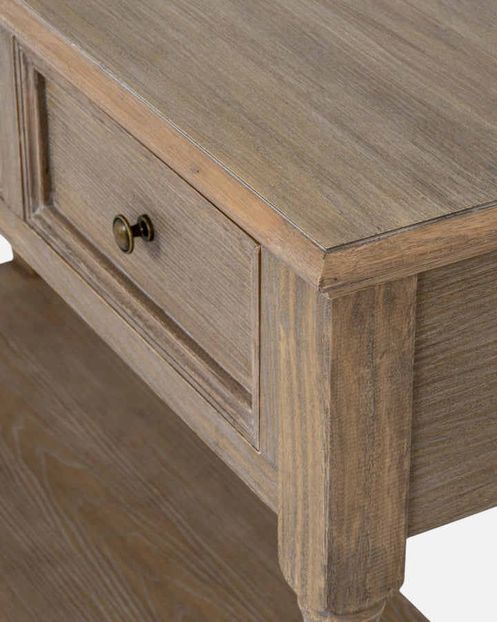 Byretto Mercer console table in light brown wood with three drawers, lower shelf, and antique brass hardware.