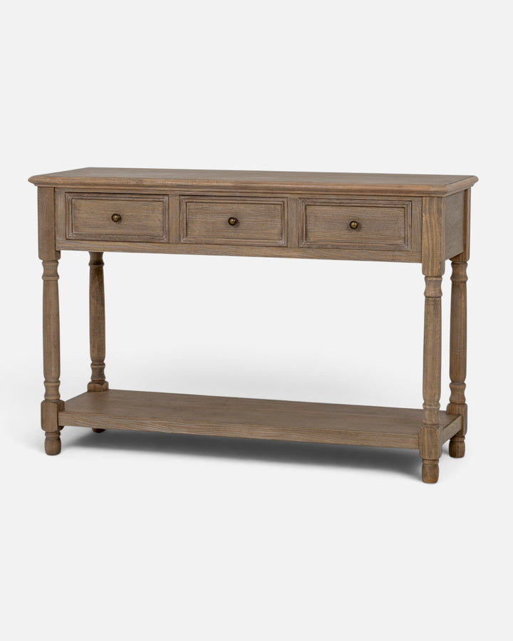 Byretto Mercer console table in light brown wood with three drawers, turned legs, and an open lower storage shelf.