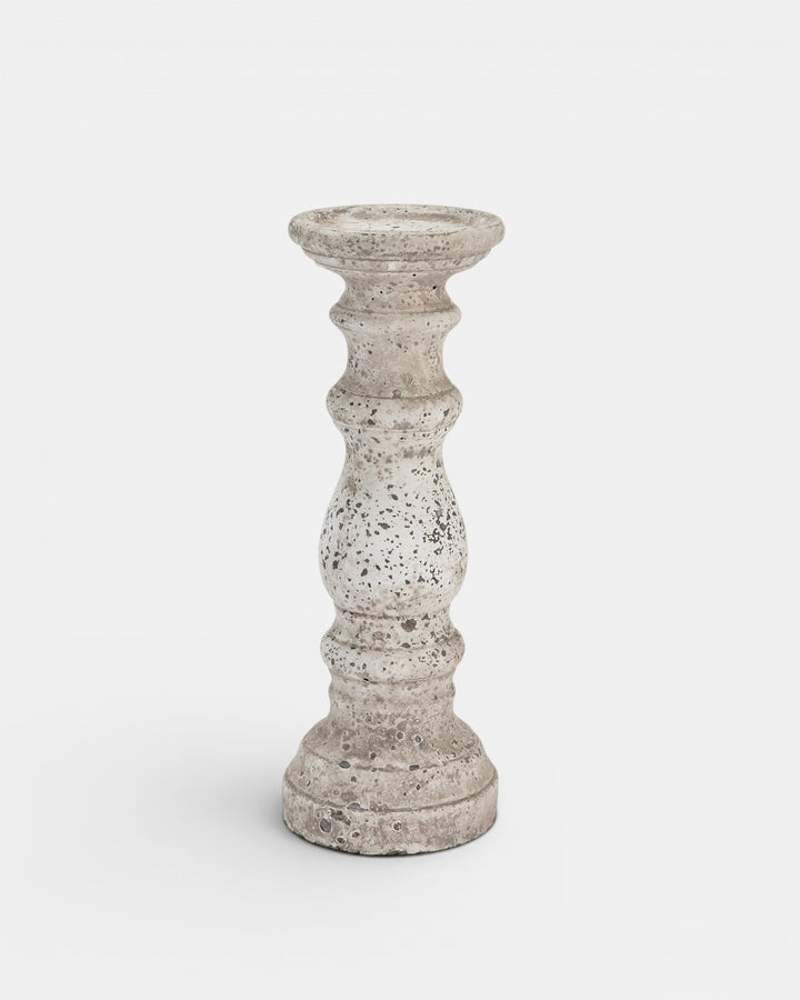 Decorative candle holder with textured surface on a white background