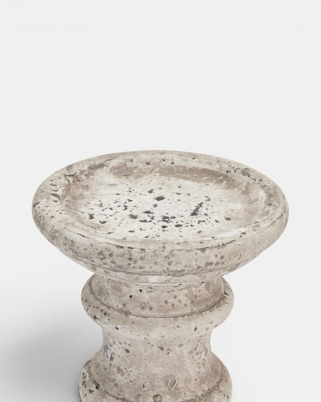 Beige candle holder with textured surface on a white background