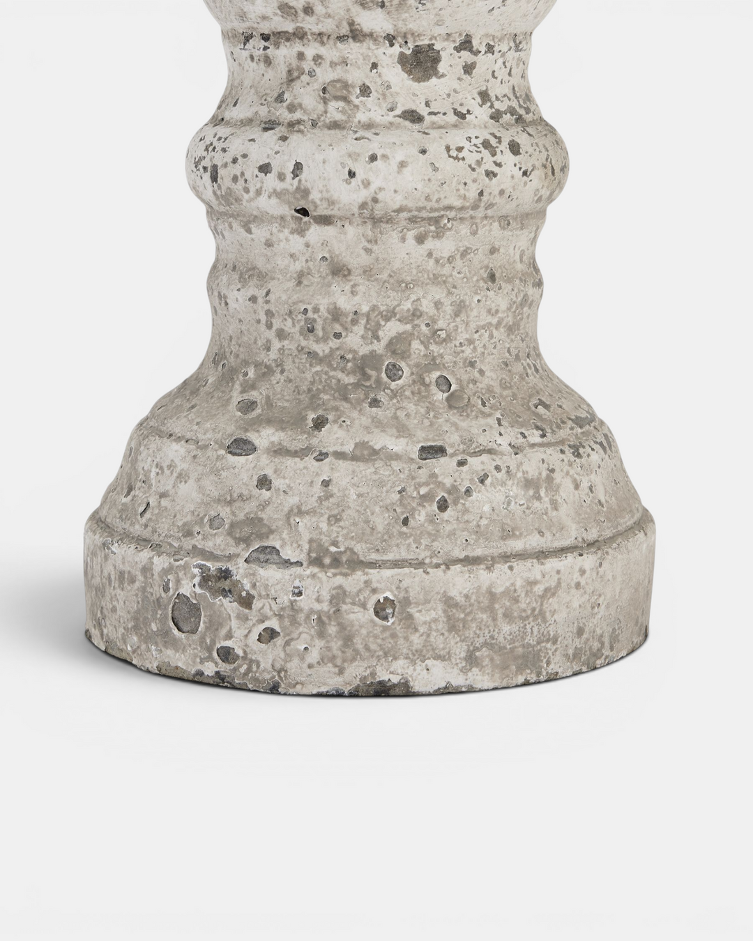 Beige candle holder base with textured surface on a white background