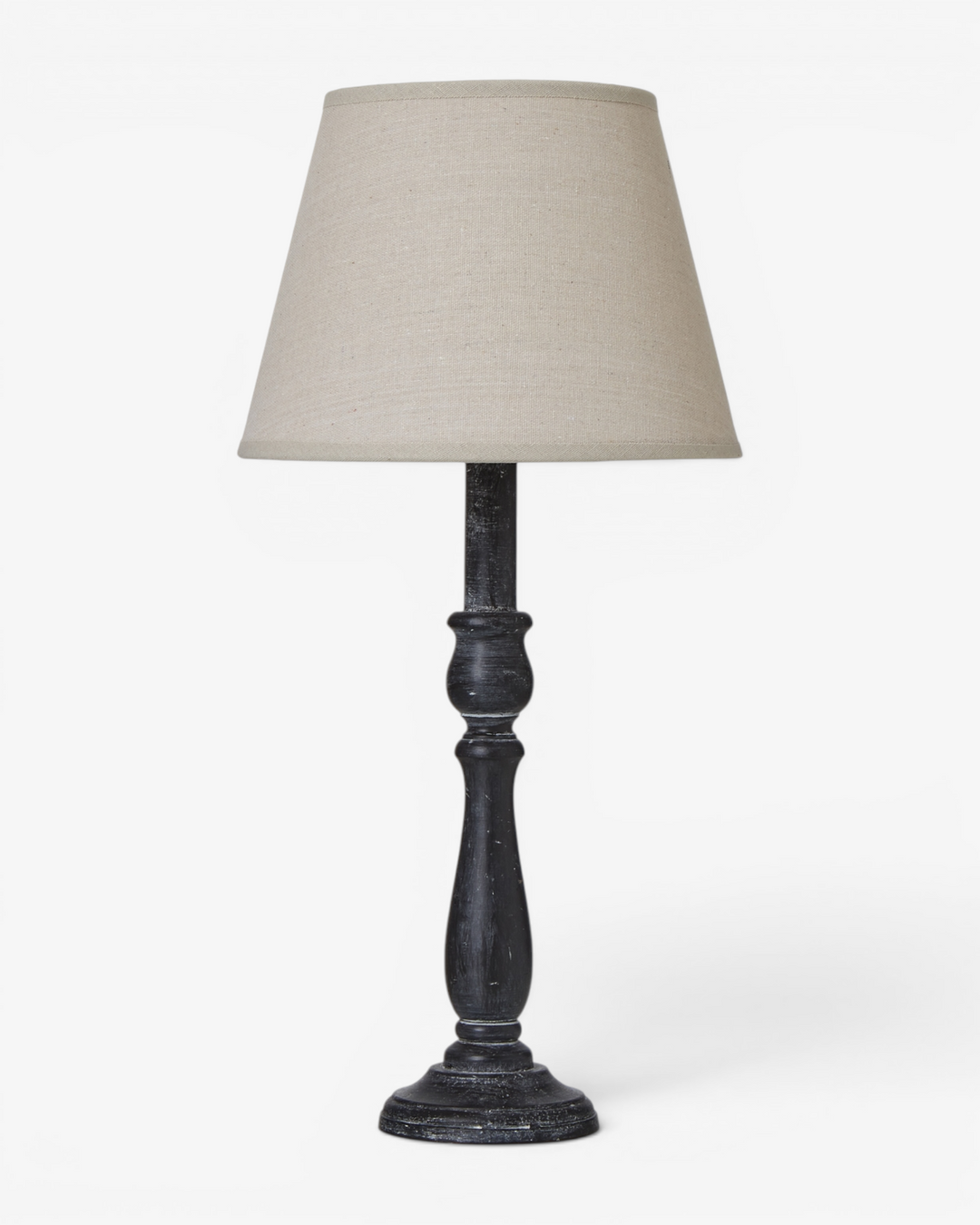 Table lamp with a dark wooden base and beige lampshade on a white background