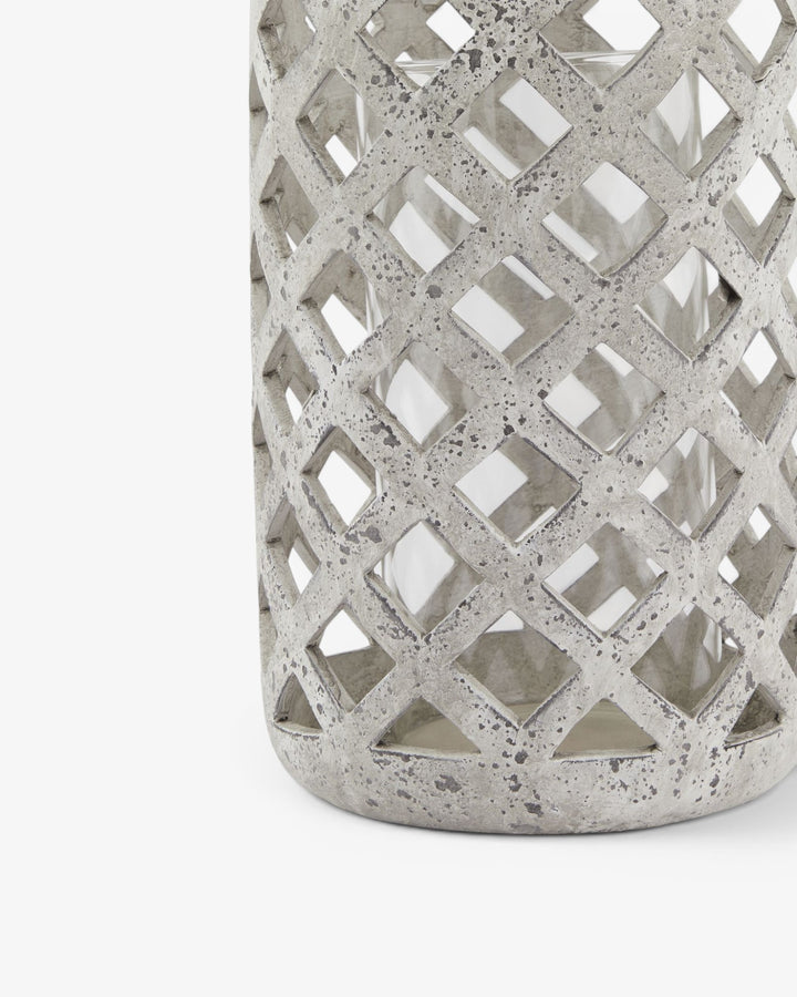 Decorative concrete lantern with lattice design on a white background