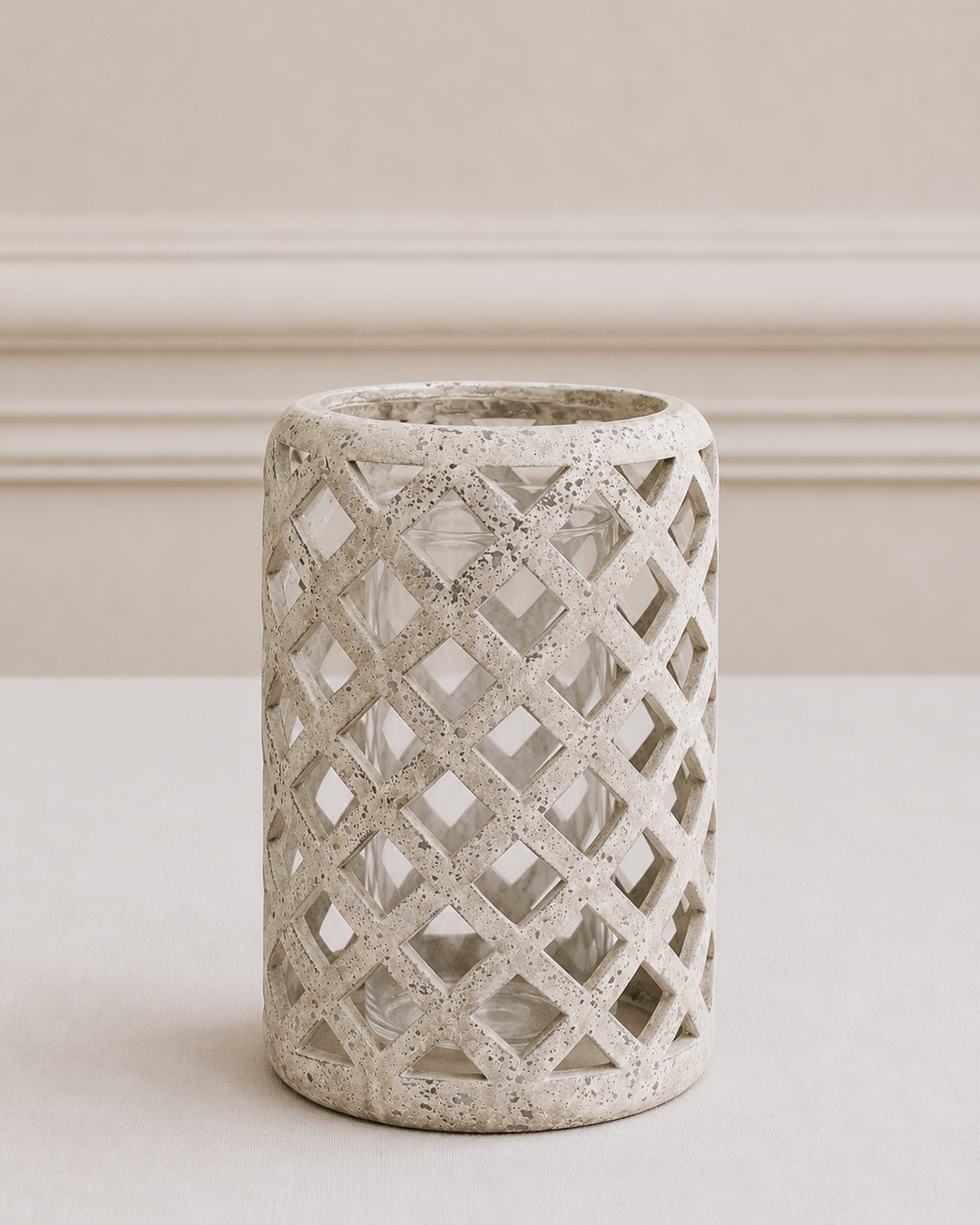 Cylindrical concrete vase with lattice pattern on a neutral background