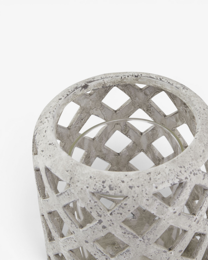 Decorative concrete lantern with lattice design on a white background