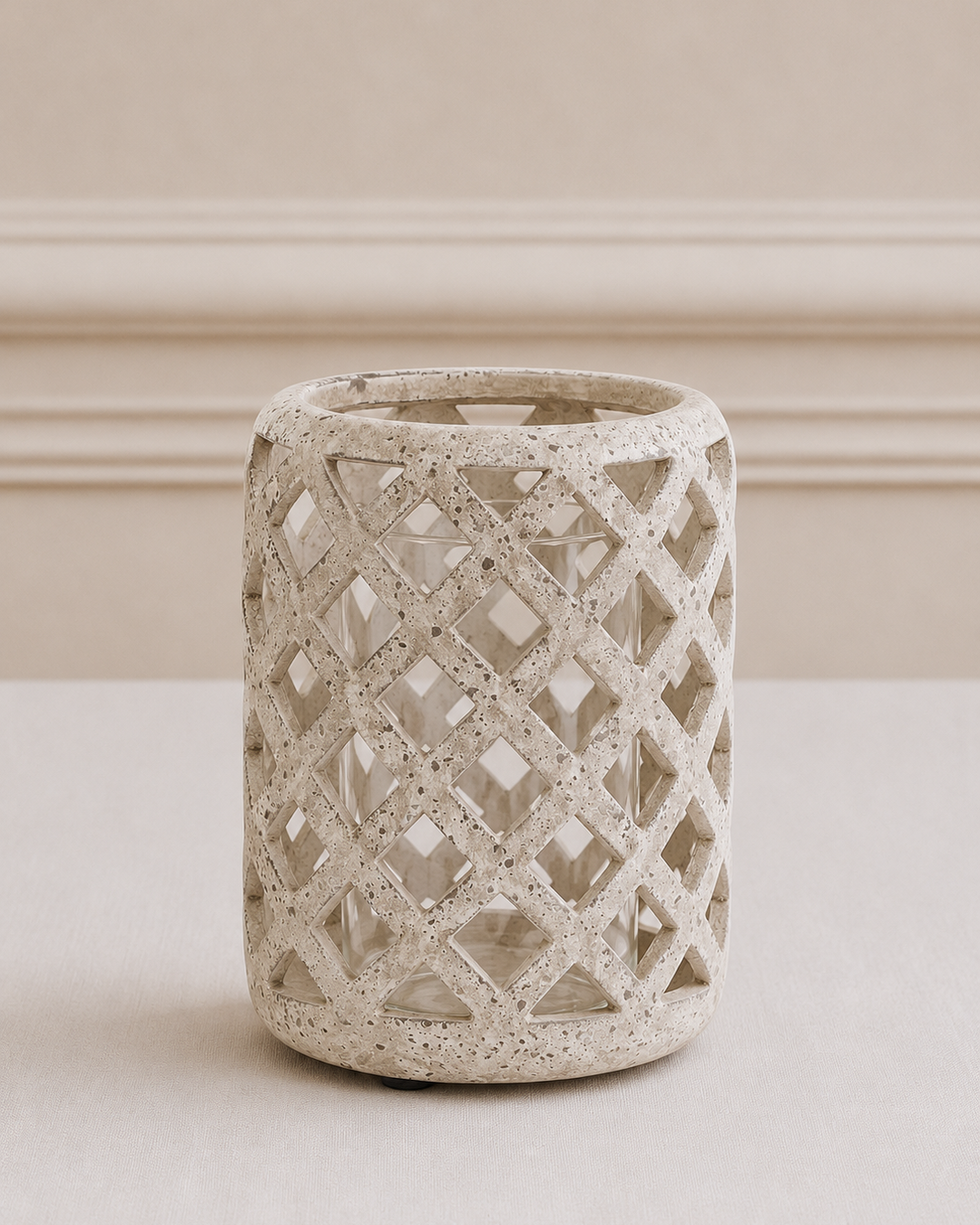Decorative concrete vase with lattice pattern on a neutral background