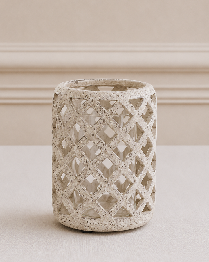 Decorative concrete vase with lattice pattern on a neutral background