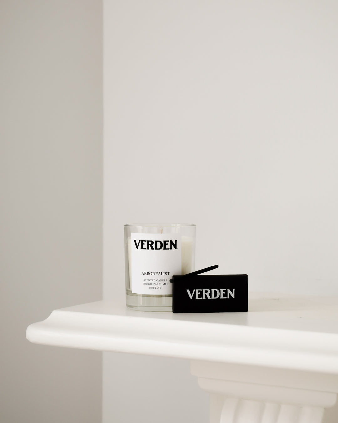 Verden candle and matches on a white surface with a neutral background