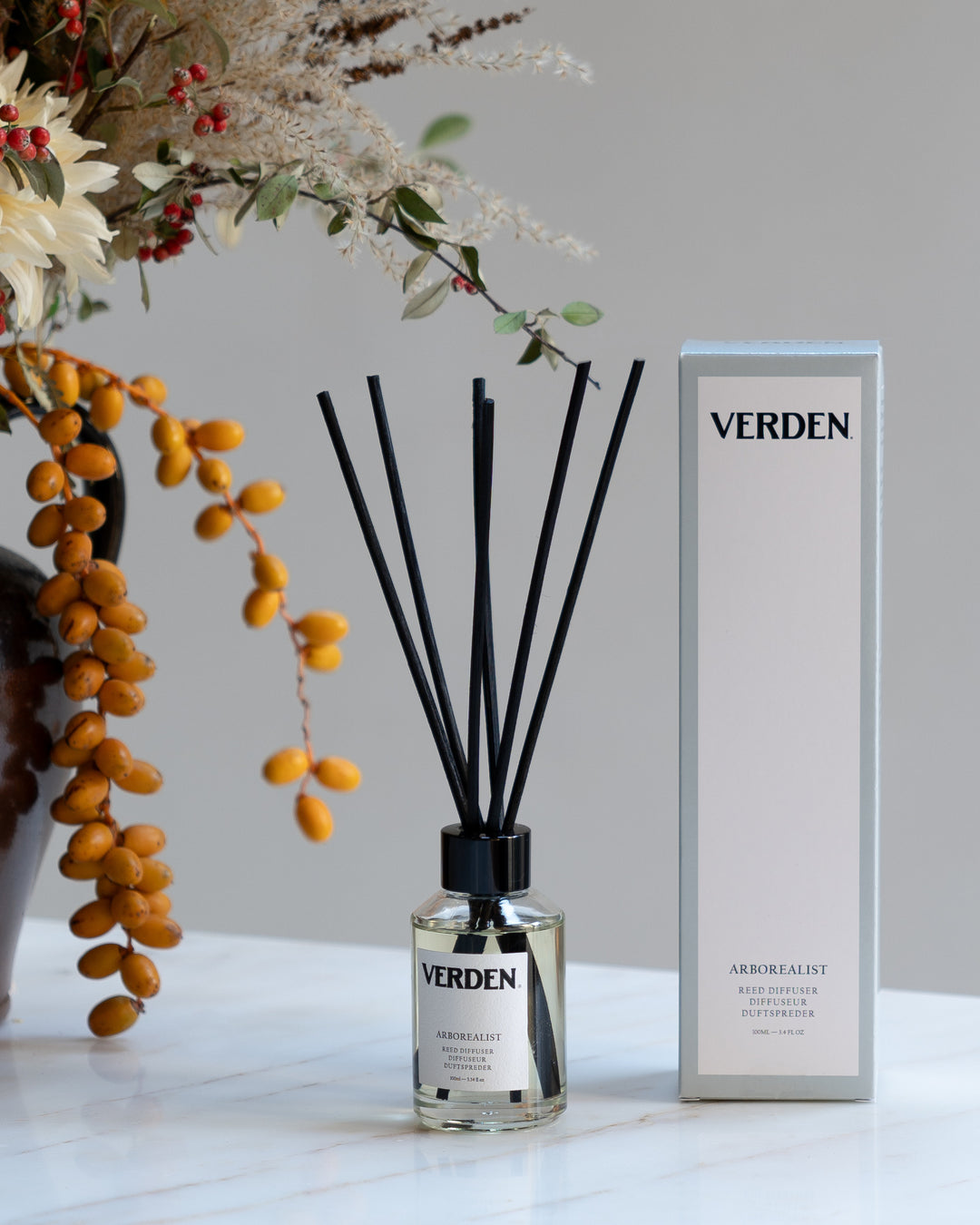 Verden diffuser bottle and packaging with decorative elements on a light surface.