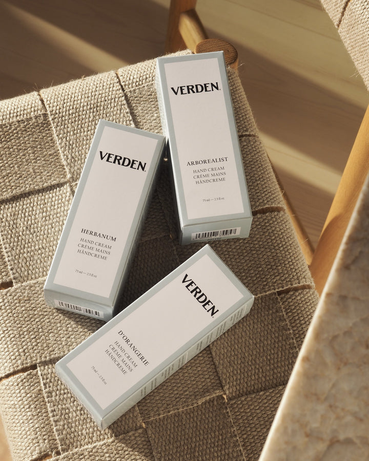 Three Verden hand cream products on a textured surface