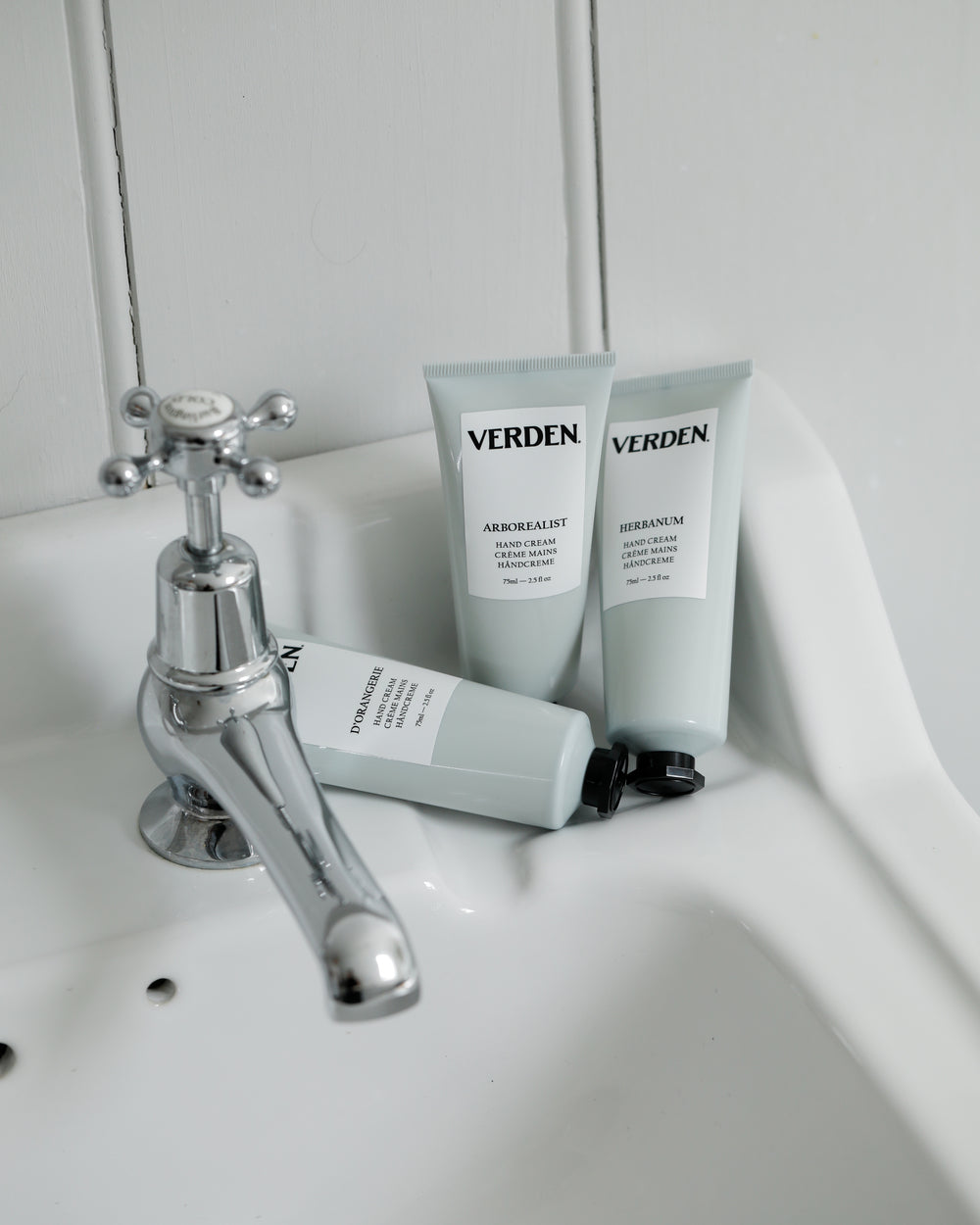 Verden hand cream products on a sink with a faucet