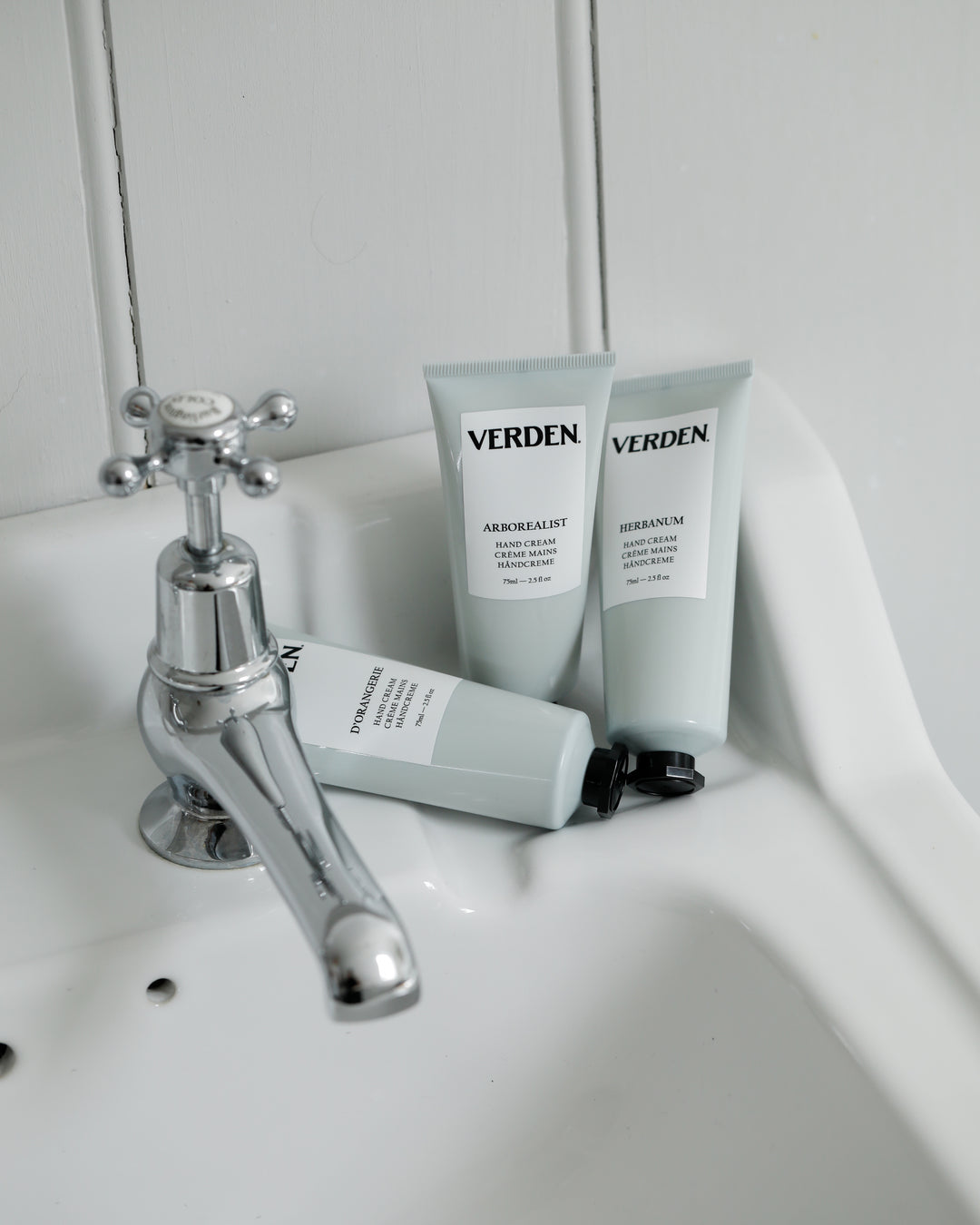 Verden hand cream products on a sink with a faucet