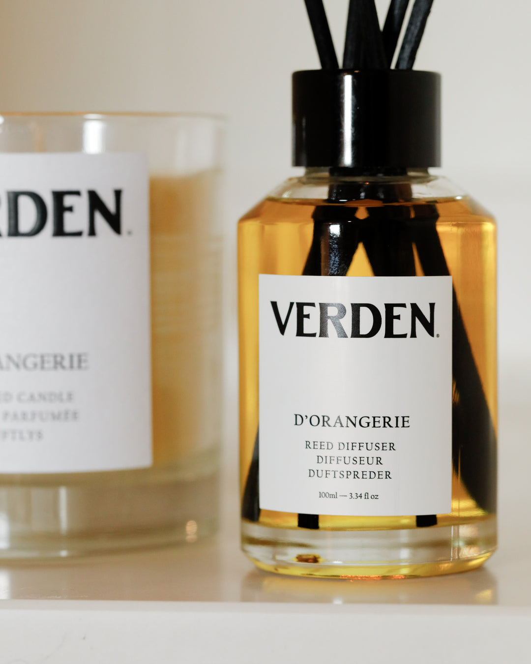 Verden diffuser bottle with candle on a white background