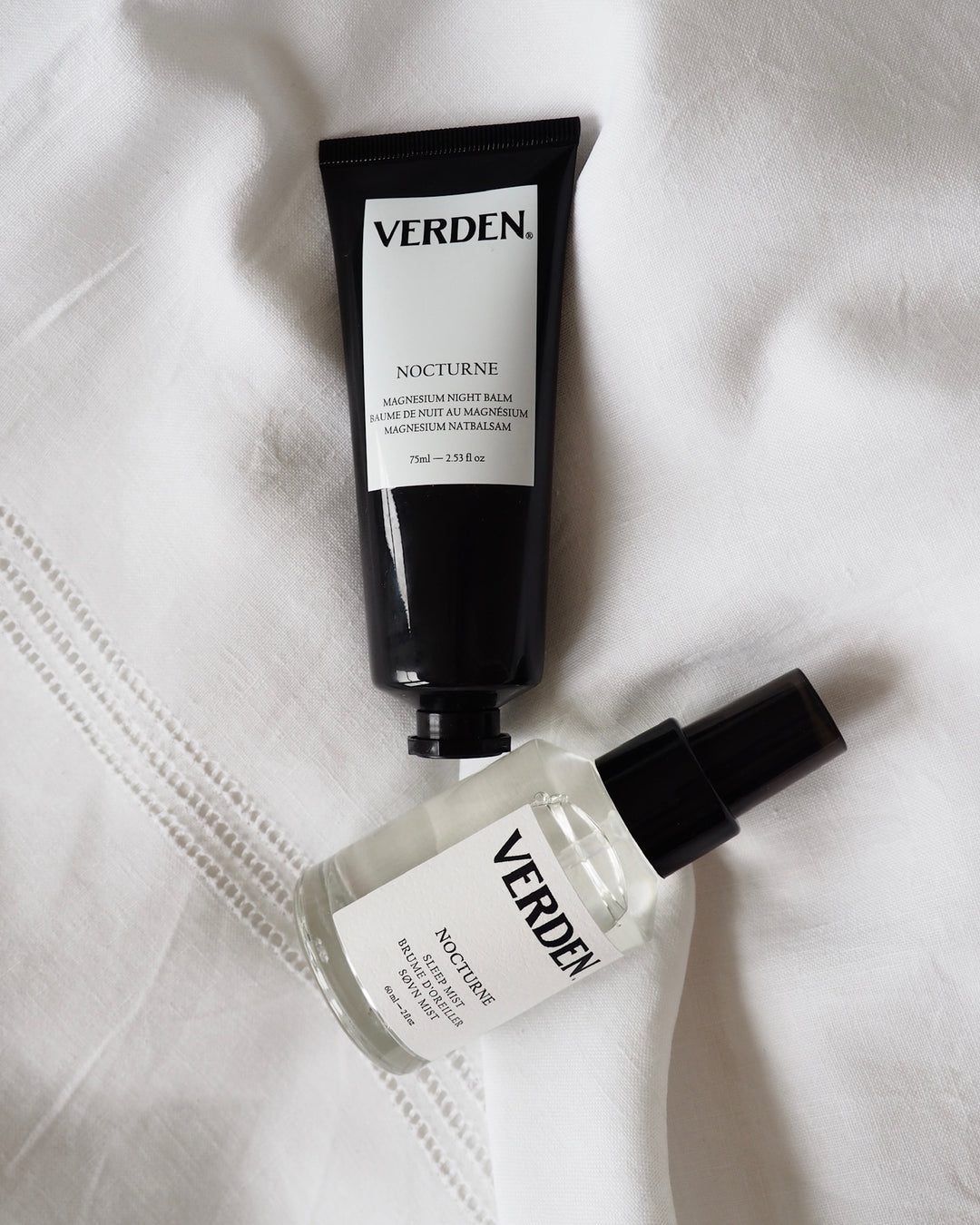 Two Verden skincare products on a white fabric background
