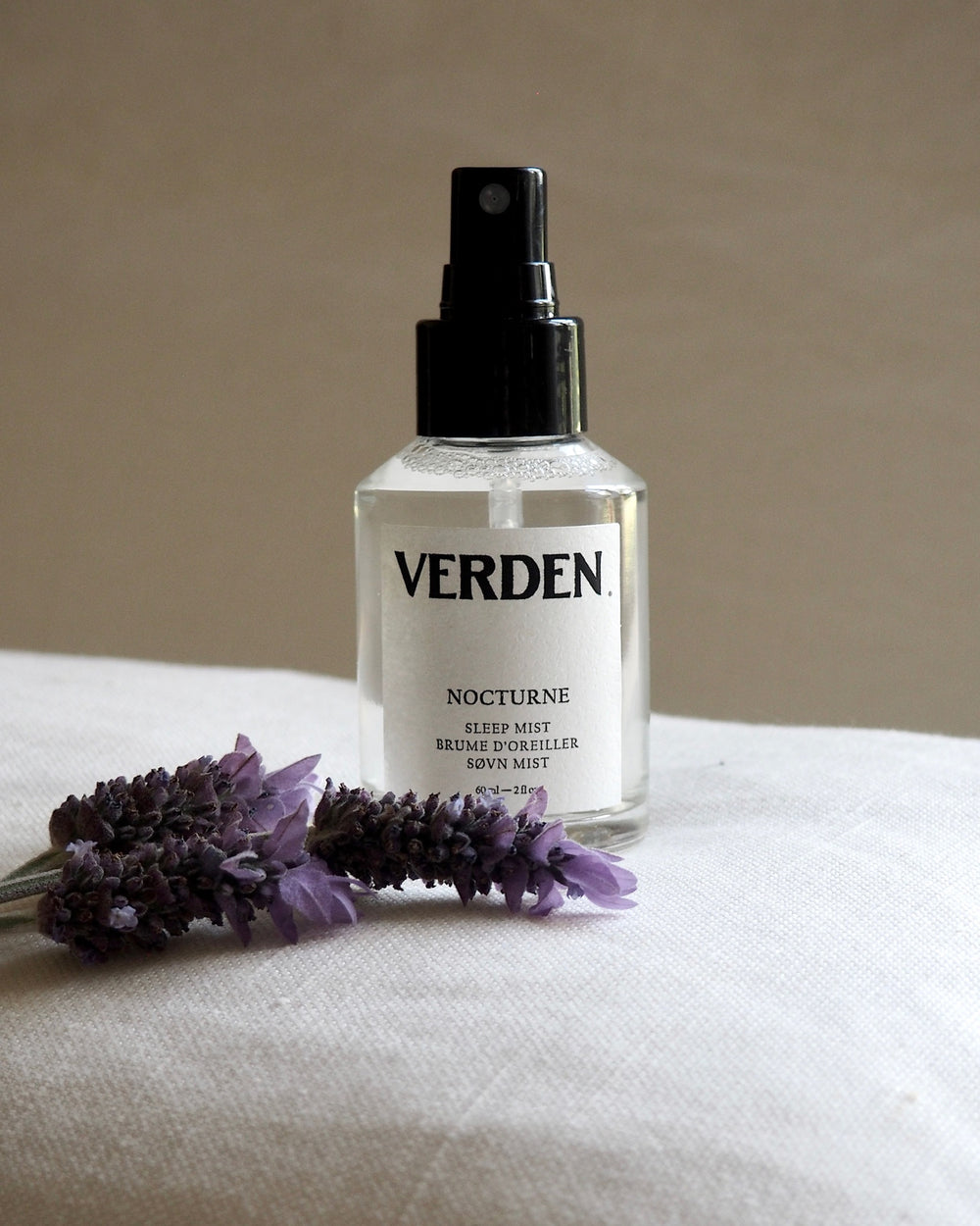 Verden Nocturne sleep mist bottle with lavender flowers on a beige background