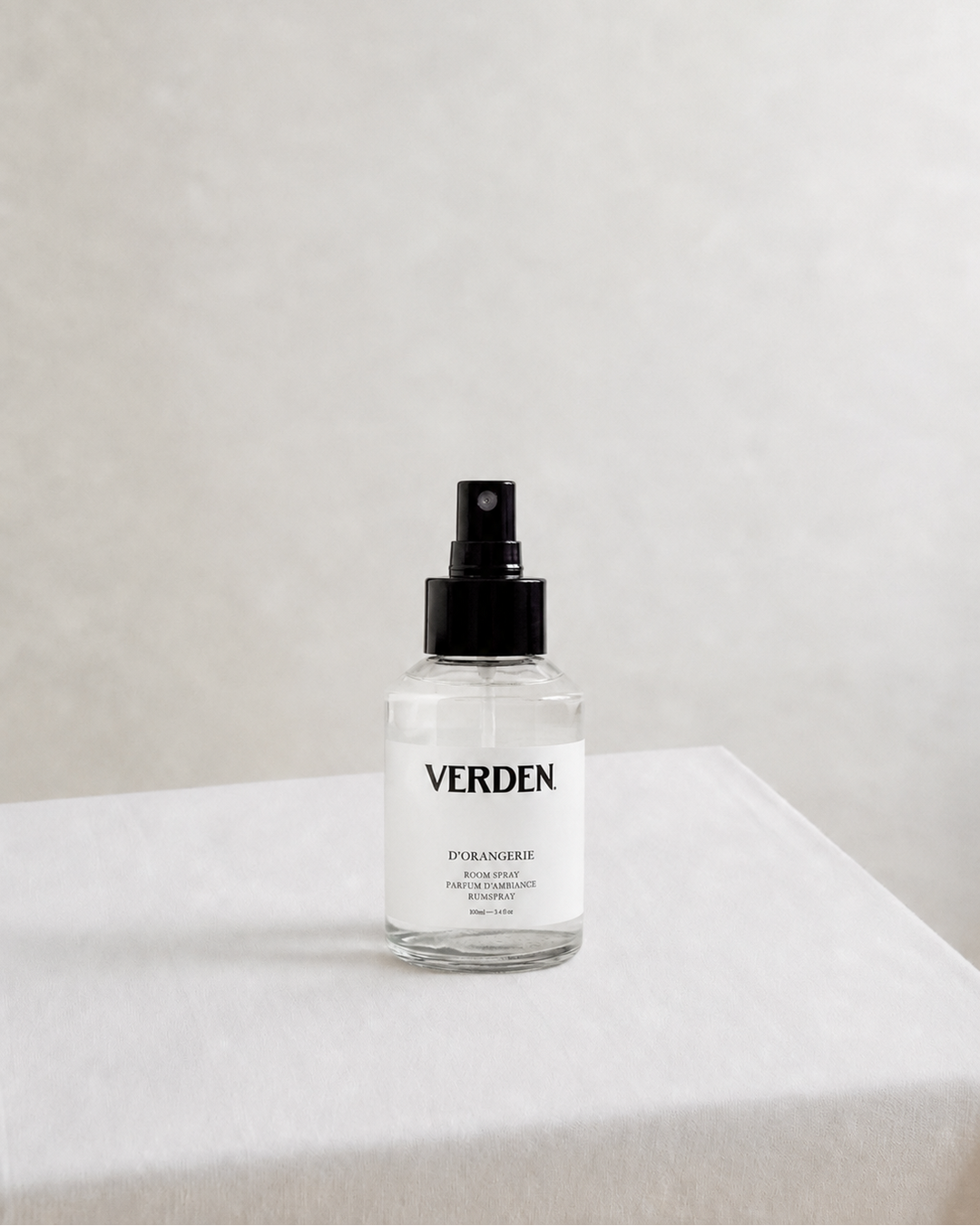 Clear spray bottle labeled 'VERDEN' on a white surface with a light gray background