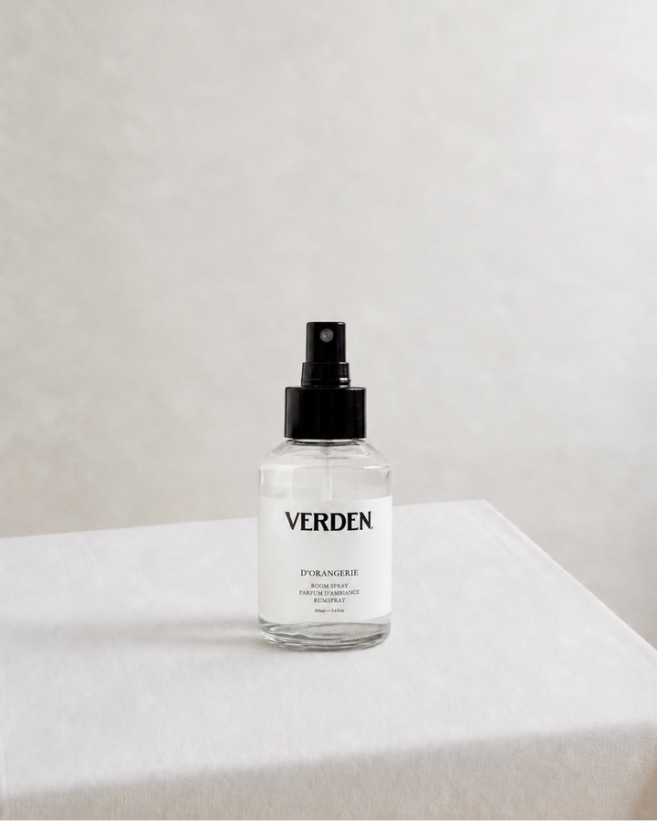 Clear spray bottle labeled 'VERDEN' on a white surface with a light gray background