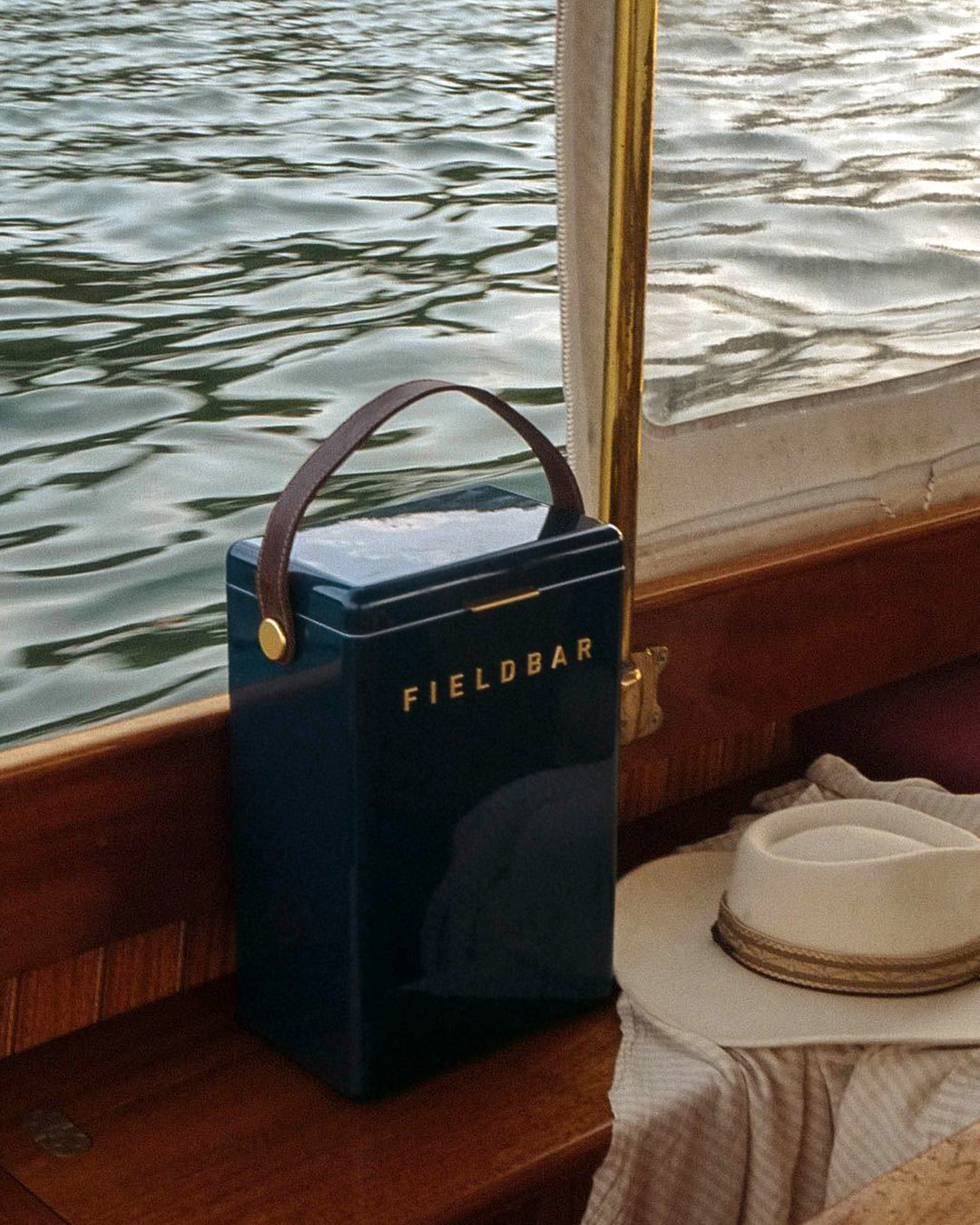 Blue Fieldbar drinks cooler product on a boat with water in the background