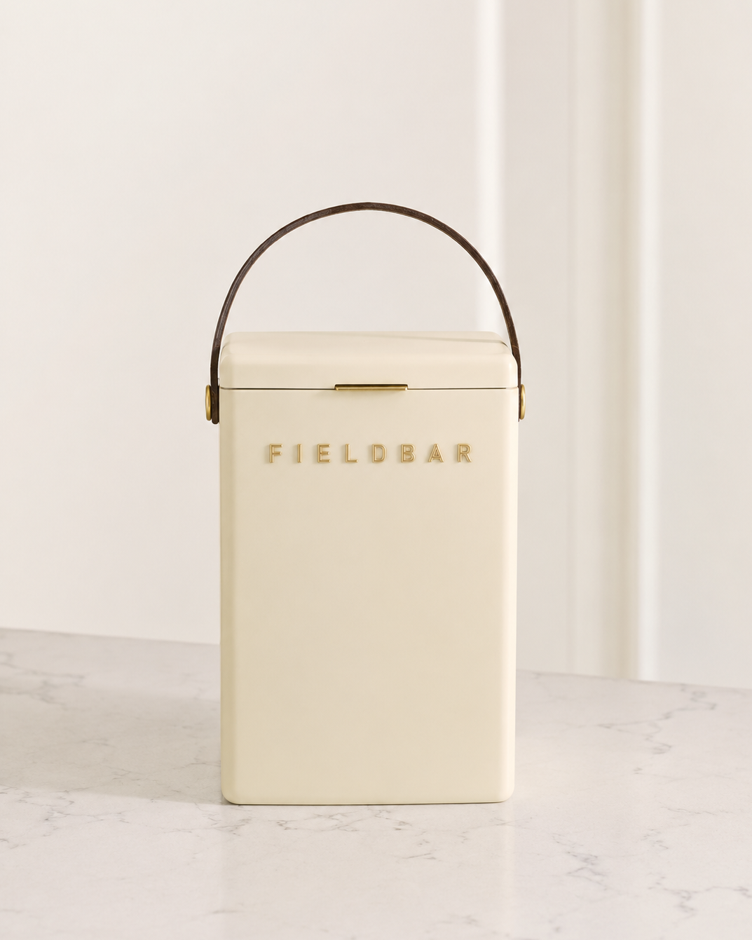 Cream-colored cooler with 'Fieldbar' branding on a light background