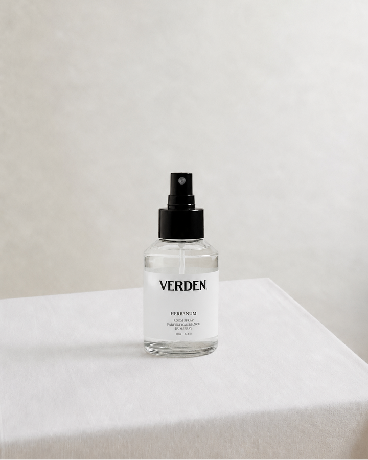 Clear spray bottle labeled 'VERDEN' on a white surface with a light gray background