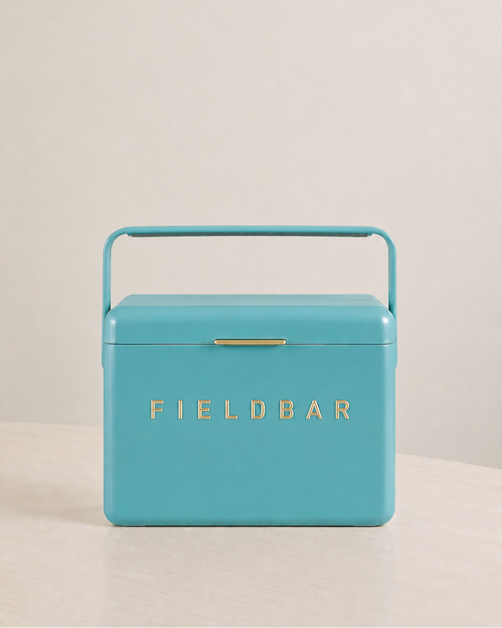Turquoise cooler box with 'FIELDBAR' branding on a beige background